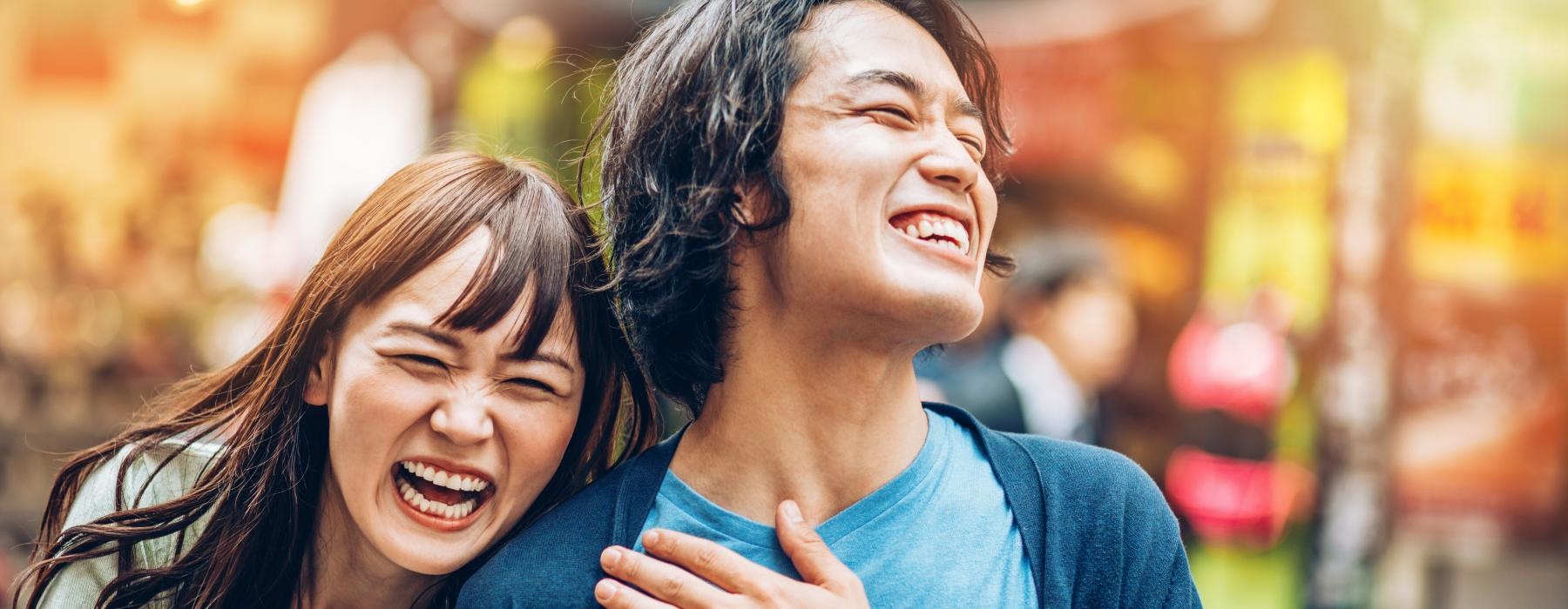 a man and a woman laughing in the city