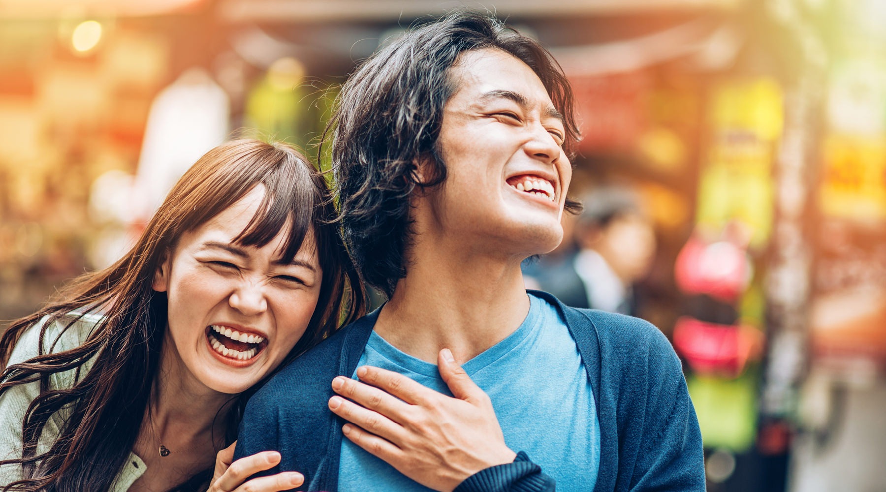 a couple laughing and walking