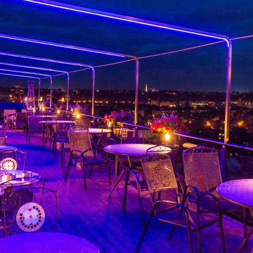 The essence of exceptional living a group of tables and chairs on a rooftop terrace