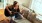 a woman playing the guitar on a sofa