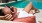 a woman lying on a towel by a pool